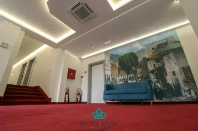 a room with a blue couch and a painting on the wall at Hotel Vezir Palace in Travnik