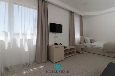 a hotel room with a bed and a television at Hotel Vezir Palace in Travnik