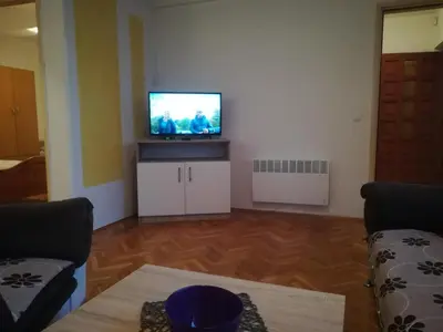 a living room with a flat screen tv on a wall at Apartman Lidija in Livno