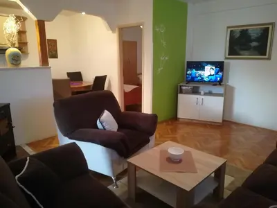 a living room with two chairs and a coffee table at Apartman Lidija in Livno
