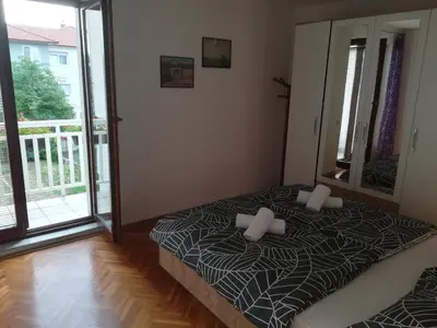 a bedroom with a bed and a large window at Apartman Lidija in Livno