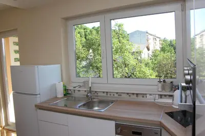 a kitchen with a sink and a large window at Magnolija in Banja Luka
