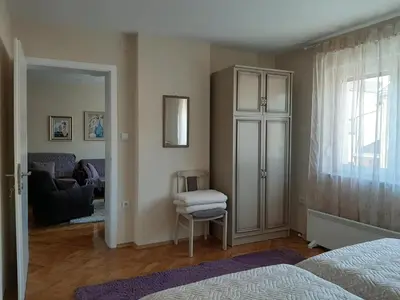 a bedroom with a door open to a living room at Magnolija in Banja Luka