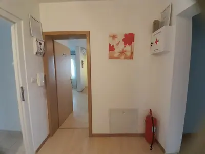 a hallway with a hallway leading to a room at River Bank Apartments & Castle view in Bihać