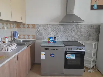 a kitchen with a stove and a sink at River Bank Apartments & Castle view in Bihać