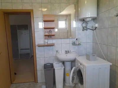 a bathroom with a sink and a toilet and a sink at River Bank Apartments & Castle view in Bihać