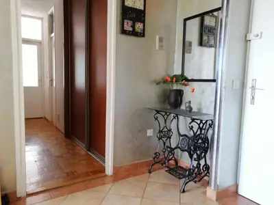 a hallway with a console table in a house at Apartman Maja in Banja Luka