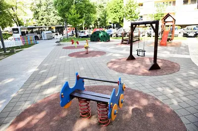 a park with a playground with a swing at Apartman Maja in Banja Luka