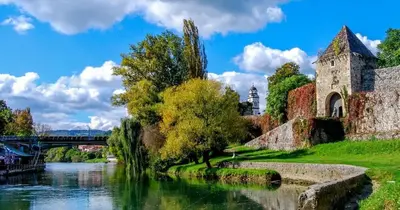 an old building next to a river with a bridge at Apartman Maja in Banja Luka