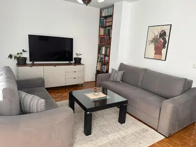 a living room with a couch and a tv at Apartman Maja in Banja Luka
