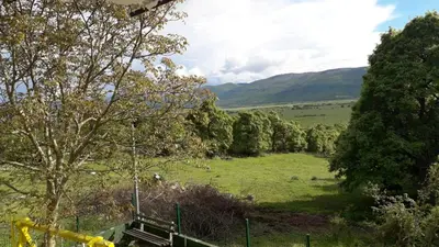 a view of a field with trees and hills at Weekend House Petar in Lusnić