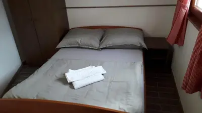 a small bed with two towels sitting on it at Weekend House Petar in Lusnić