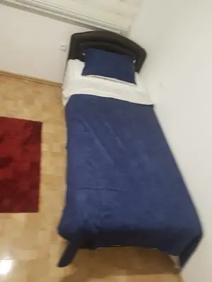 a bed with blue sheets and blue pillows at Apartment Centar LUX in Banja Luka