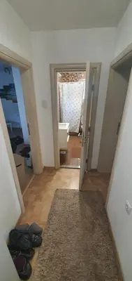 a view of a bathroom with a toilet and a hallway at Apartment Centar LUX in Banja Luka