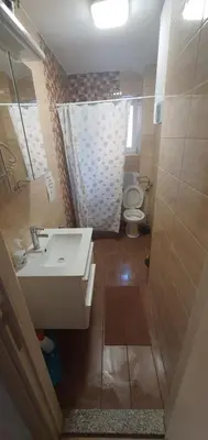 a bathroom with a sink and a toilet at Apartment Centar LUX in Banja Luka