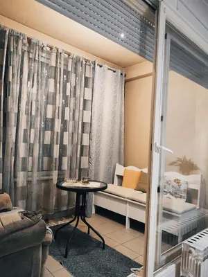 a living room with a table and a couch at Apt Ana in Banja Luka