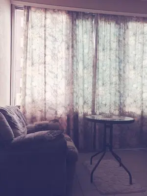 a living room with a couch and a table in front of a window at Apt Ana in Banja Luka