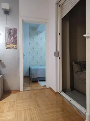 a room with a door to a bedroom with a bed at Apt Ana in Banja Luka