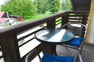 a table and chairs on a balcony with a view at Riverside apartment #1. View over Fortress Kastel in Banja Luka