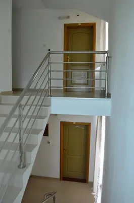 a staircase with a metal railing and a door at Motel Signal in Banja Luka