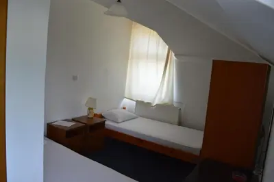 a small room with a bed and a window at Motel Signal in Banja Luka