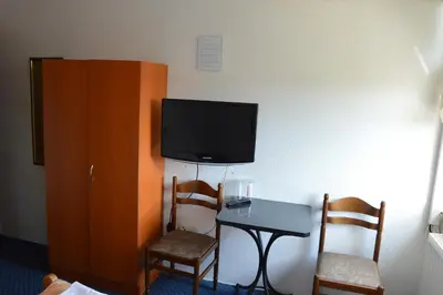 a room with a table and a flat screen tv at Motel Signal in Banja Luka