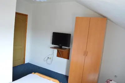 a bedroom with a bed and a cabinet and a television at Motel Signal in Banja Luka