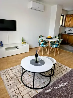 a living room with a table and two chairs at Apartman Baljak in Livno