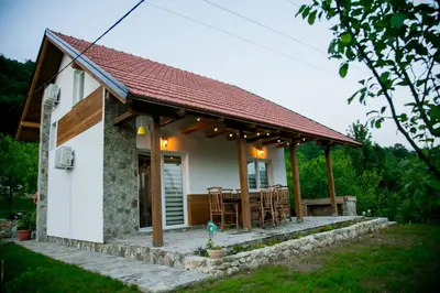 a small white house with a table and chairs at Nektar Park Villa Sara in Bihać
