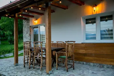 a wooden table and chairs on a patio at Nektar Park Villa Sara in Bihać