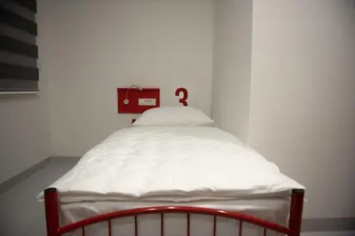 a small bed with a question mark on the back at Hostel Boje in Livno