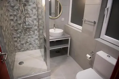 a bathroom with a shower and a sink and a toilet at Hostel Boje in Livno