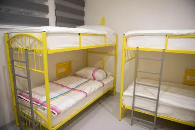 two yellow bunk beds in a room with at Hostel Boje in Livno