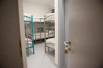 a room with two bunk beds and a door at Hostel Boje in Livno