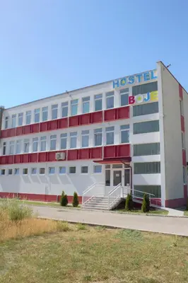 a hospital building with a red and white facade at Hostel Boje in Livno