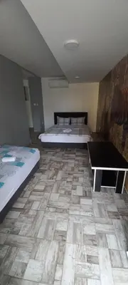 a room with two beds and a table in it at SOBE ROOMS GAVRILO in Banja Luka