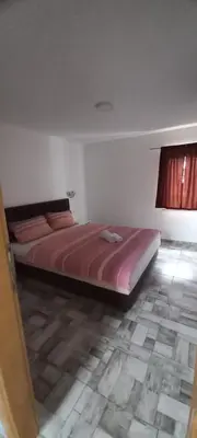 a bedroom with a large bed in a room at SOBE ROOMS GAVRILO in Banja Luka