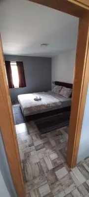 a bedroom with a bed in a room with a mirror at SOBE ROOMS GAVRILO in Banja Luka