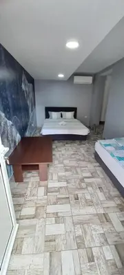 a bedroom with a bed and a table in a room at SOBE ROOMS GAVRILO in Banja Luka