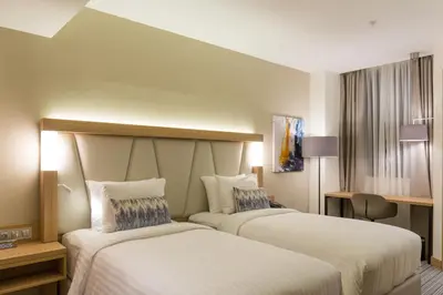 a hotel room with two beds in a room at Courtyard by Marriott Banja Luka in Banja Luka