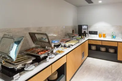 a kitchen with some food on a counter at Courtyard by Marriott Banja Luka in Banja Luka