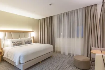 a hotel room with a bed and a table at Courtyard by Marriott Banja Luka in Banja Luka