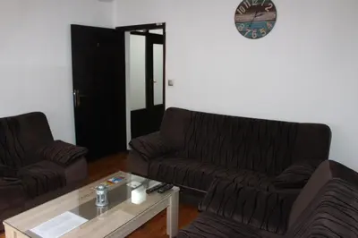 a living room with two couches and a coffee table at Apartmani Ramonda in Teslić