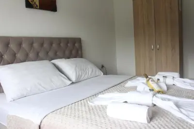 a bed with white towels and a banana on it at Apartmani Ramonda in Teslić