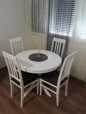 a white table with two chairs and a white table and chairsktop at Apartman MMS in Teslić