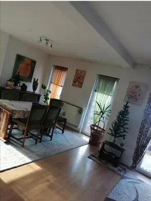 a living room with a dining room table and chairs at Apartment AMRA in Tuzla