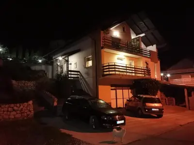 a car parked in front of a house at night at Apartment AMRA in Tuzla
