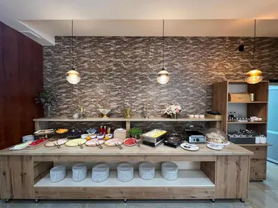 a kitchen with a counter with food on it at HOTEL Villa Grande in Bugojno
