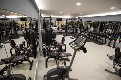 a gym with a bunch of exercise equipment in it at HOTEL Villa Grande in Bugojno