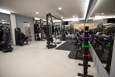 a gym with lots of treadmills and machines at HOTEL Villa Grande in Bugojno